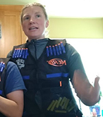 A photo of Kristen Jones wearing a Nerf vest talking.