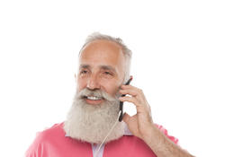 A smiling older man in a pink shirt speaks on a mobile phone