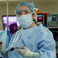 A female surgeon performing a procedure.