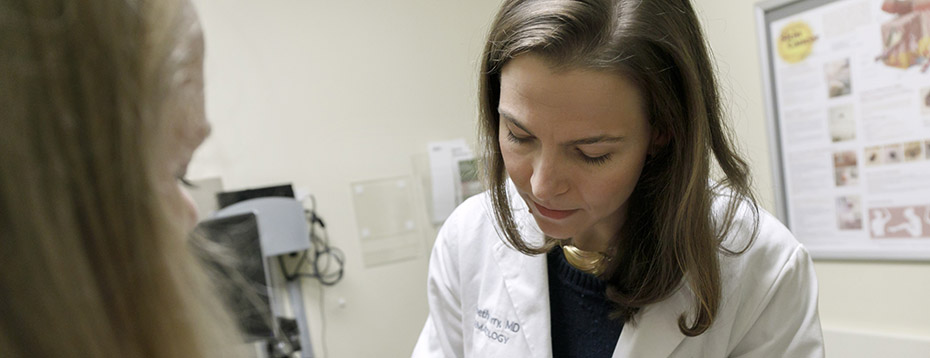 Dr. Elizabeth Berry with a patient in a dermatology clinic