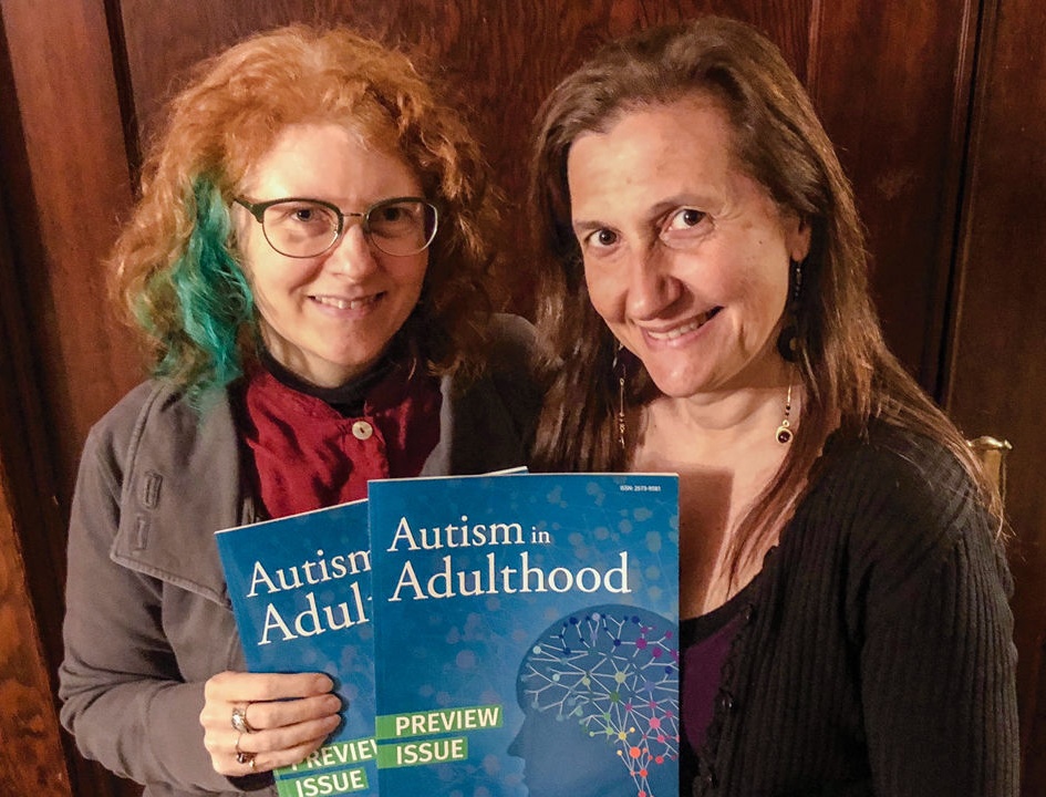 Drs. Dora Raymaker and Christina Nicolaidis holding the new journal, Autism in Adulthood, that their work was published in.