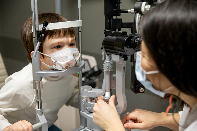 A child receives an eye exam from a pediatric ophthalmologist in the Elks Children's Eye Clinic.