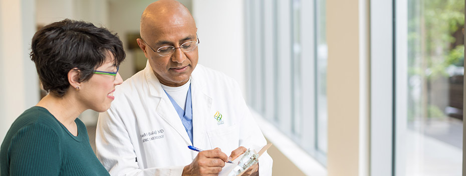 Photo of Dr. Seshadri Balaji in a hallways with a patient's family member