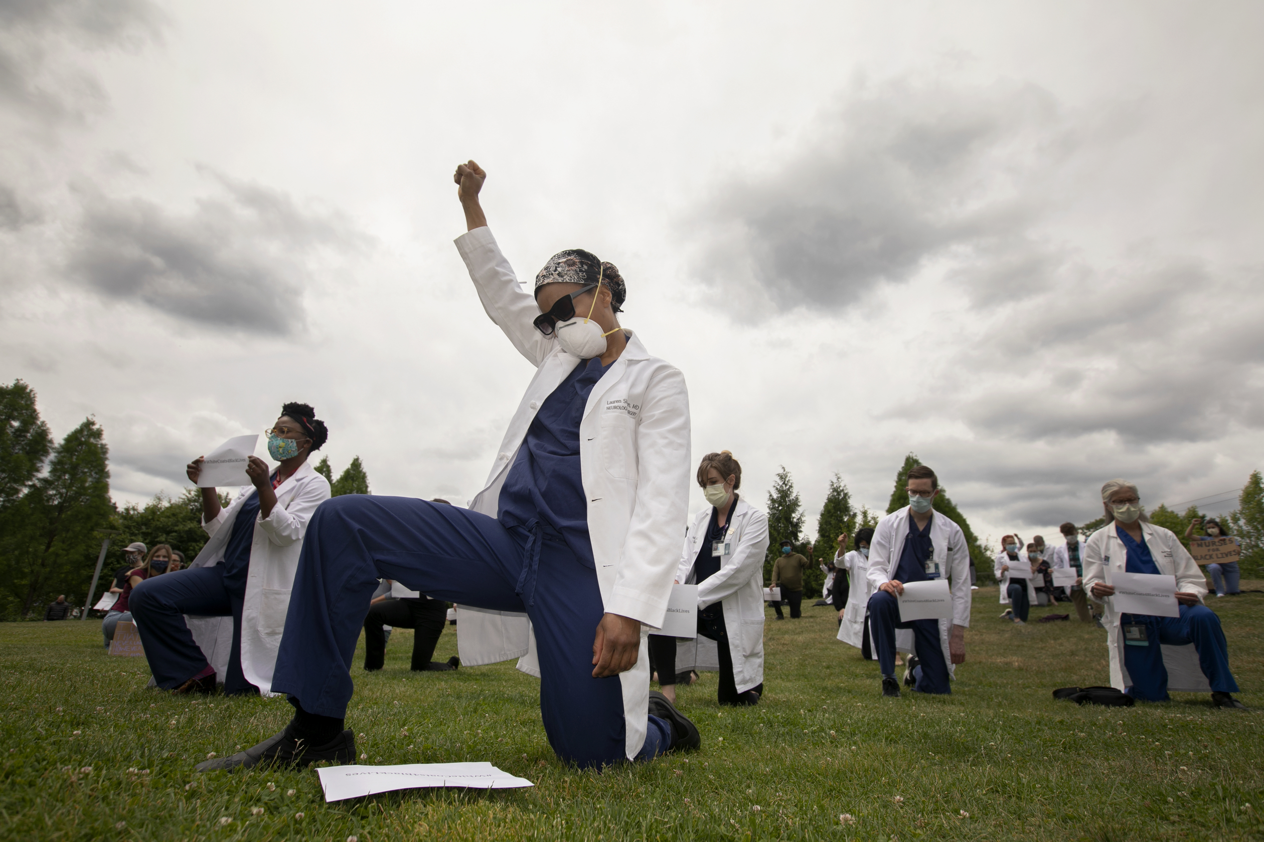 People kneeling at the White Coats 4 Black Lives Event in June 2020.