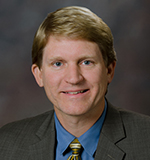 A professional photo of Dr. Jim Chesnutt from OHSU's Brain Institute.