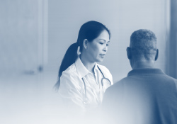 Stylized gray tone image with provider talking to patient in clinical setting