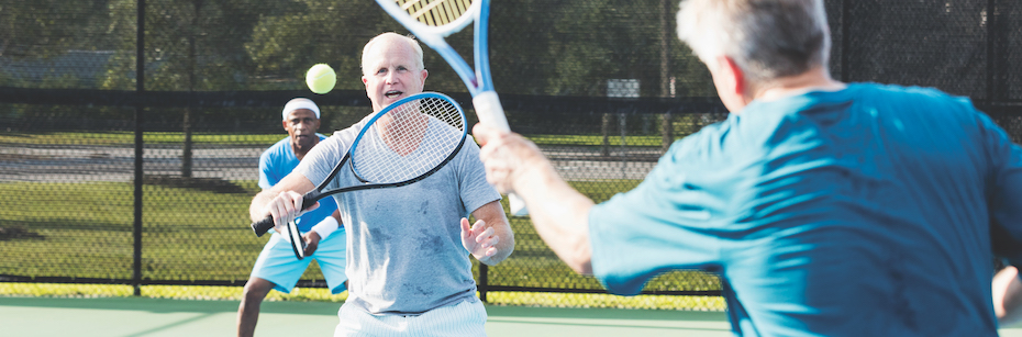 Stock photo of people playing tennis outside