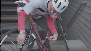 Karl Kajomo Moritz adjusting his custom-made velodrome racing bicycle