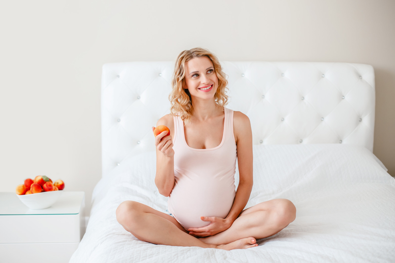 pregnant woman holding peach