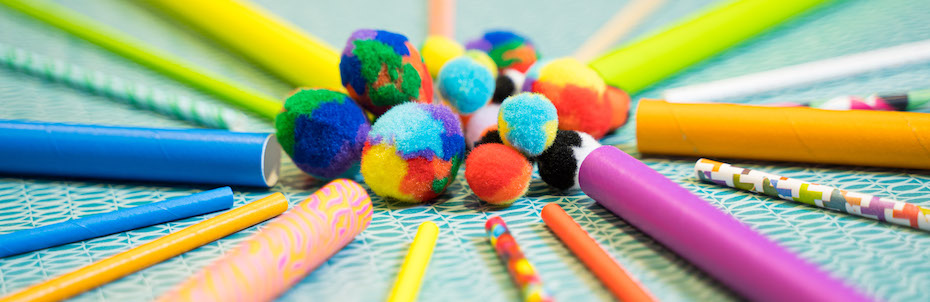 Photo of straws and fuzzy pompoms arranged in a circle