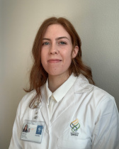 Alanna McCarthy in white OHSU lab coat