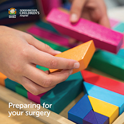 The cover image of OHSU Doernbecher Children's Hospital's "Preparing for Your Surgery" book which shows a close-up of a child's hands playing with blocks.