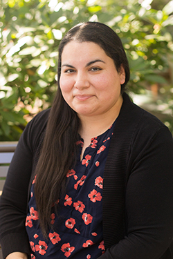 A photo of Fatima Salas sitting on a bench outside.