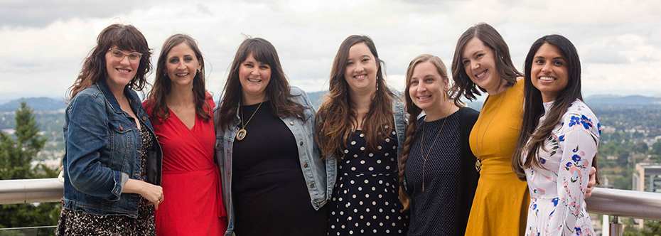 A group photo of the 2020 class of OHSU OB/GYN Residents standing on a balcony.
