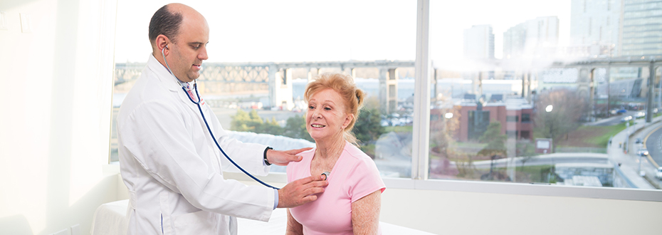 Dr. Cetnar uses a stethoscope during a clinic visit. 