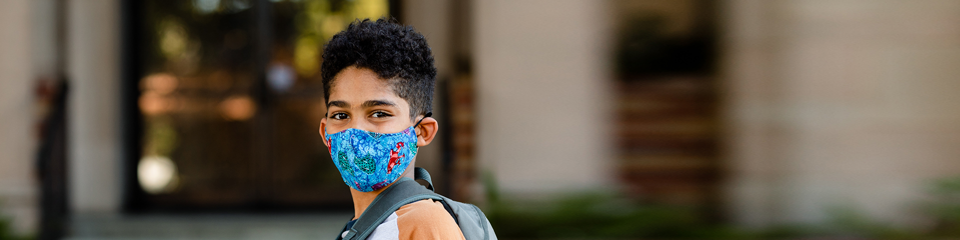 Health Magazine Fall 2021 banner image: a child wearing a face mask