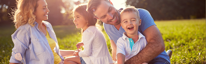 A family plays together in a park