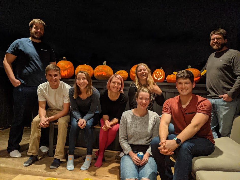 Rauch and Pruneda labs in front of their carved pumpkins