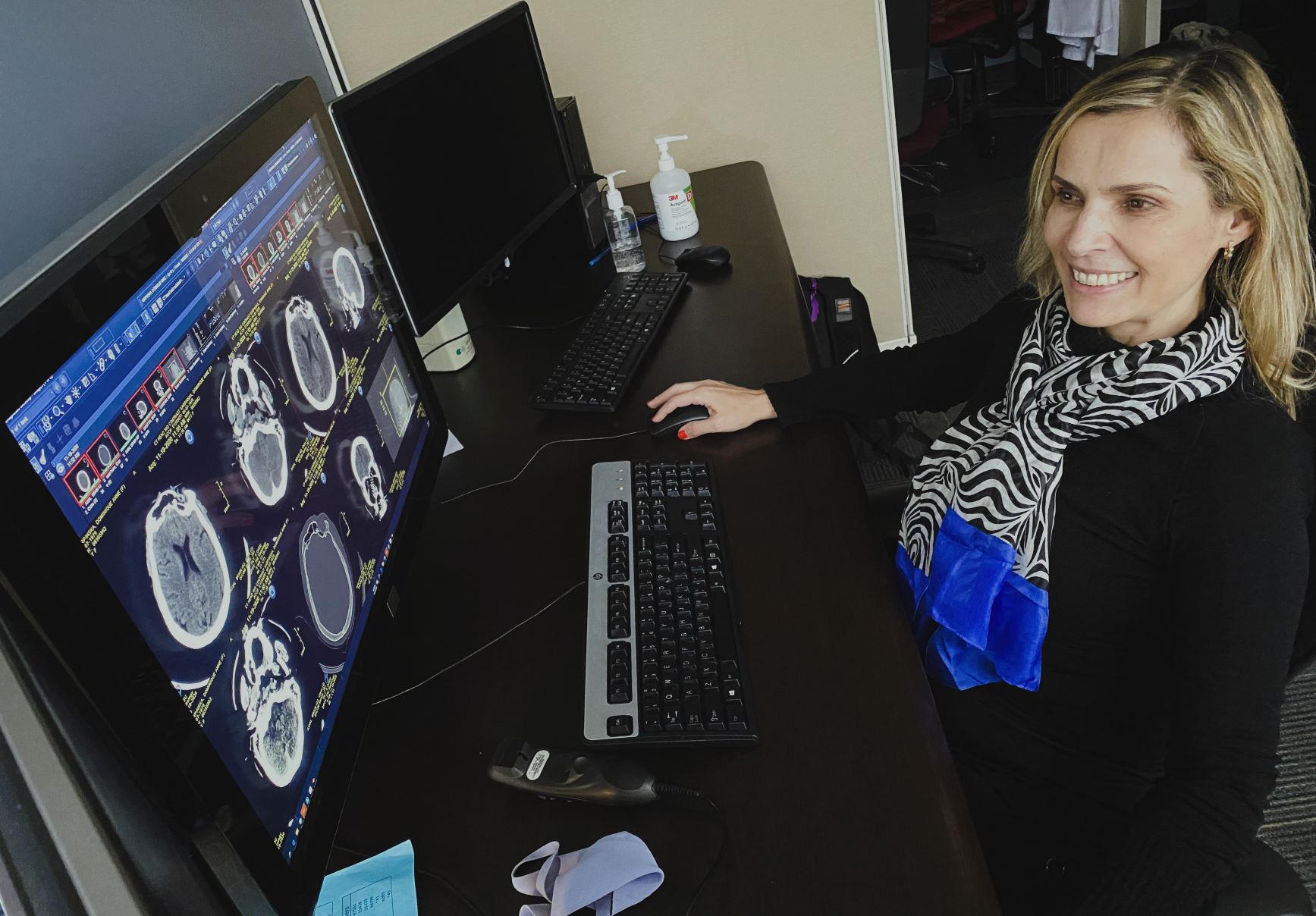 Diagnostic Radiology ABR Alt Path Fellow- Ana Santos Lima viewing a brain MRI scan on a PACS computer.