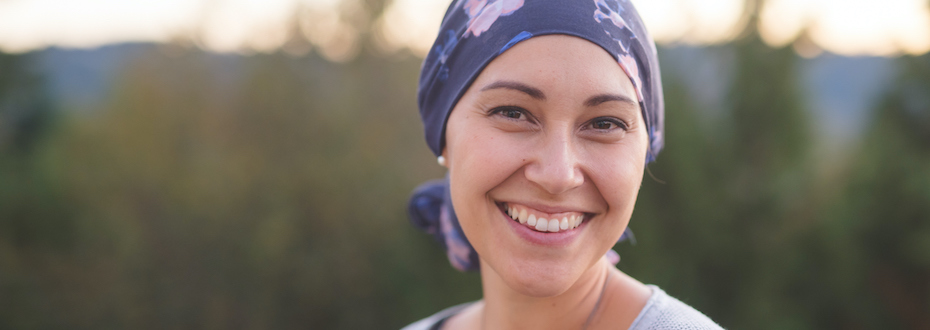Stock photo of a smiling person who is wearing a scarf on their head