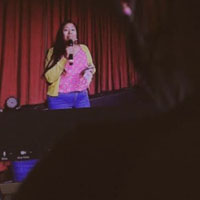 Cirila Estela Vasquez Guzman speaking into a mic on stage