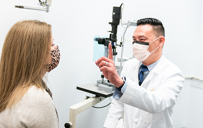 Dr. Derek Louie examines a patient.