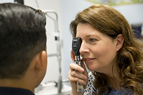 Dr. Beth Edmunds examines a child's eyes.