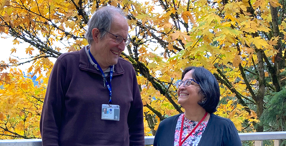Drs. Barry Oken and Amala Soumyanath standing outdoors at OHSU, smiling at each other
