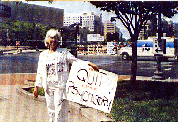 Color photograph of a banner with "Quit Psychiatry! No electric shock" as text