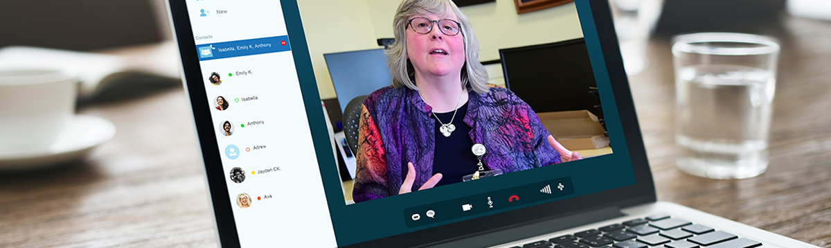 A laptop computer during a virtual conference with a speaker on the screen