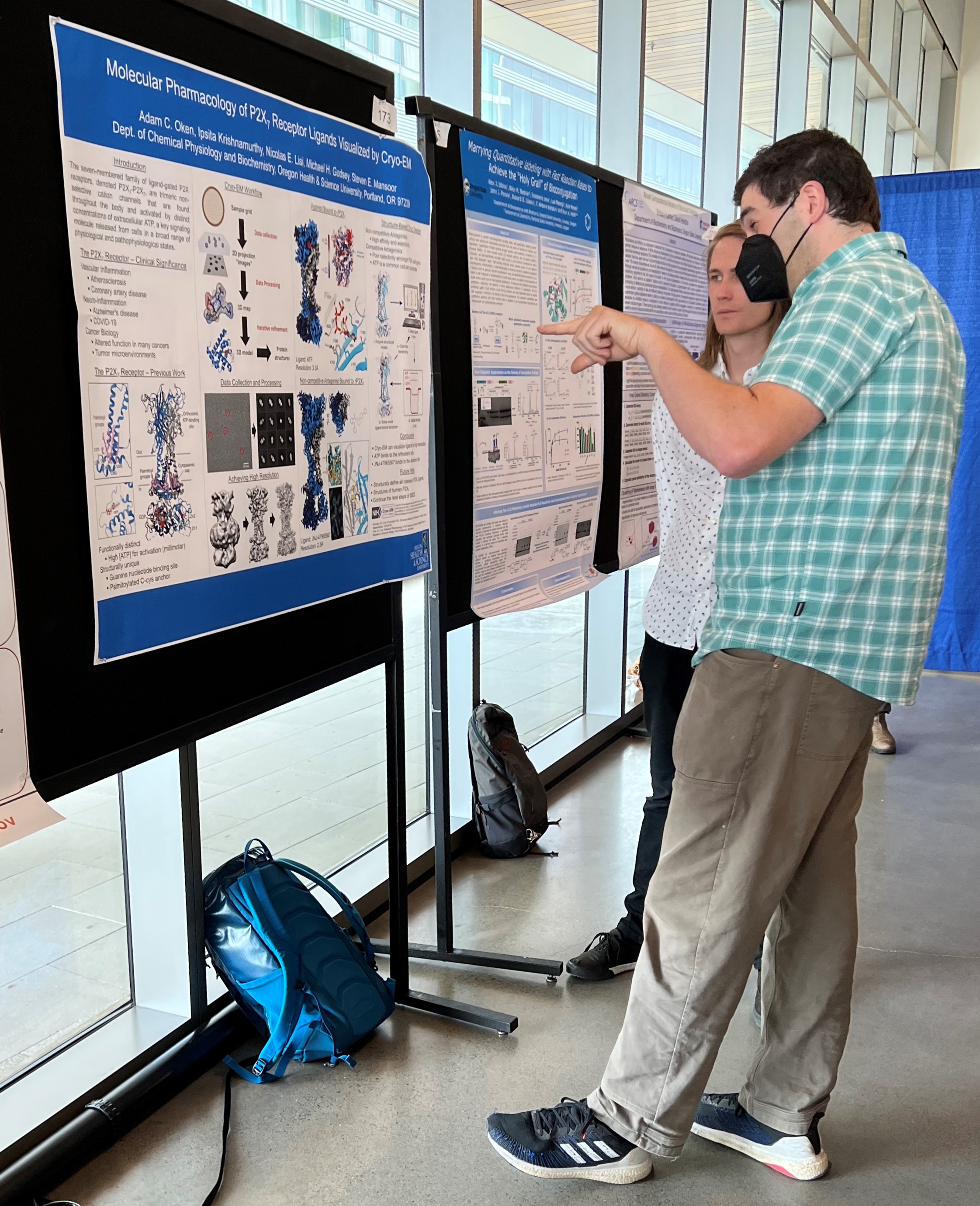 Graduate student presenting a poster.