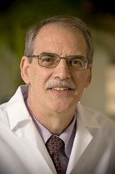 Image of Dr. Leslie Myatt. In the photo he is smiling, wearing a white coat and tie.