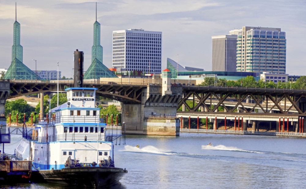 Willamette river with the Portland sternwheeler in the foreground and the Convention Center in the background