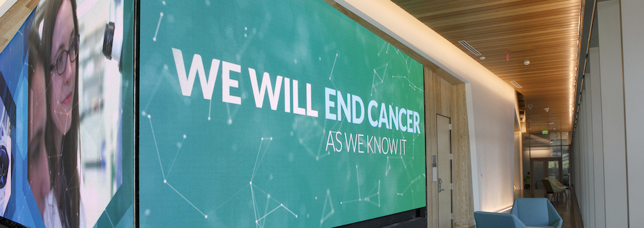 Knight Cancer Research Building interior hallway with a lighted sign saying "We will end cancer as we know it"