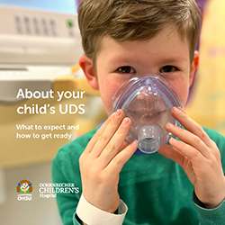 The cover of an OHSU Doernbecher Children's Hospital booklet showing a young boy smiling holding a clear breathing mask over his nose and mouth, next to text that reads "About your child's UDS" and "What to expect and how to get ready."