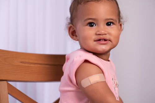 Photo of a young child with a Band-Aid on their arm