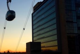 OHSU tram moving over the Center for Health and Healing at sunset.