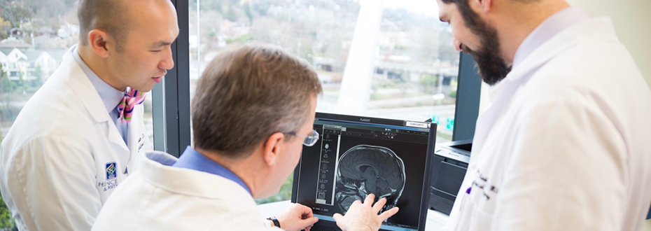 Dr. Nathan Selden and colleagues examine an MRI scan of a patient