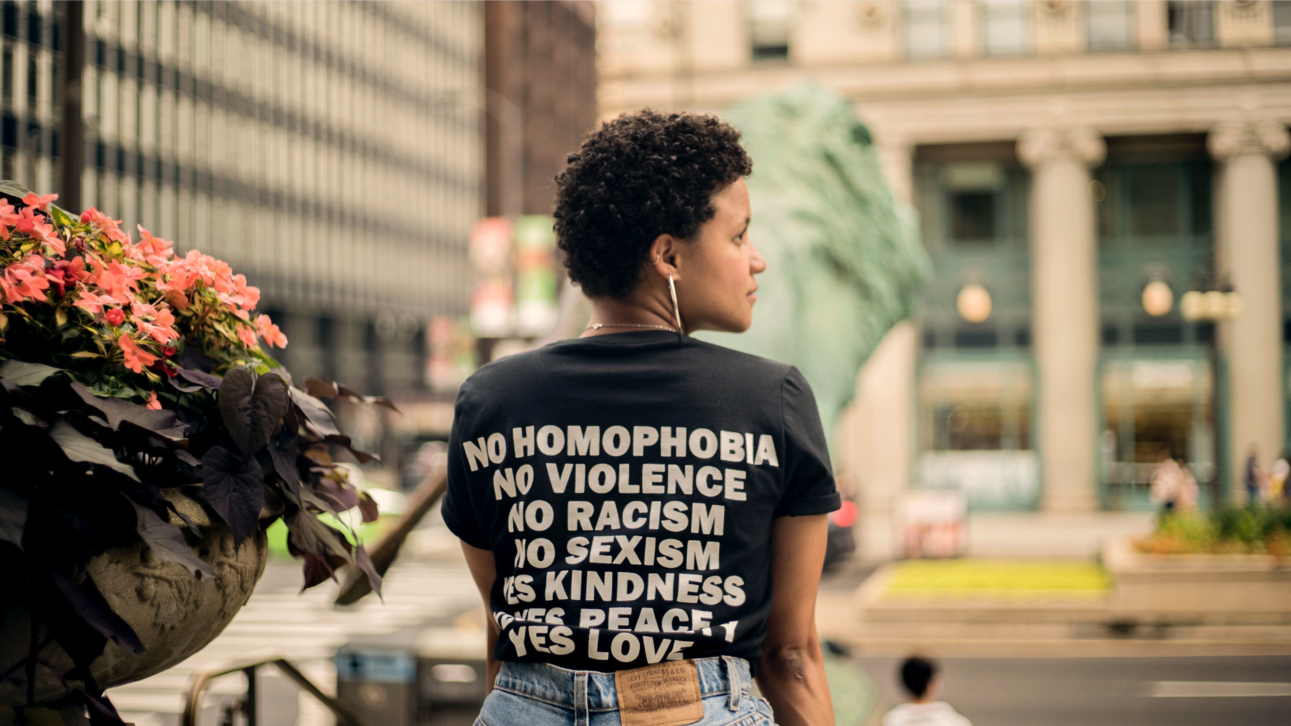 Photo of woman wearing a black shirt with equity message