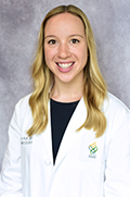 Doctor Erika Koh smiles in her white coat