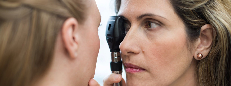 Juliette Preston, M.D., carefully examining the eye of a patient