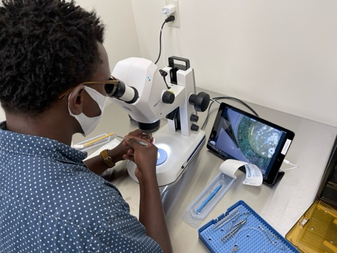 Ophthalmology resident Dr. John Placide practices in a wetlab at OHSU.