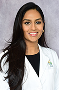 Doctor Spandana Maddukuri smiles in her white coat