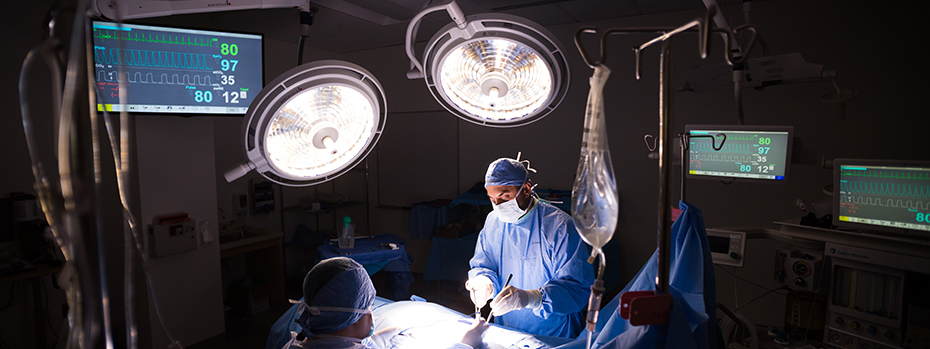 Two surgeons perform heart surgery in an OHSU operating room.