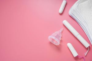 Collection of menstrural products on pink background