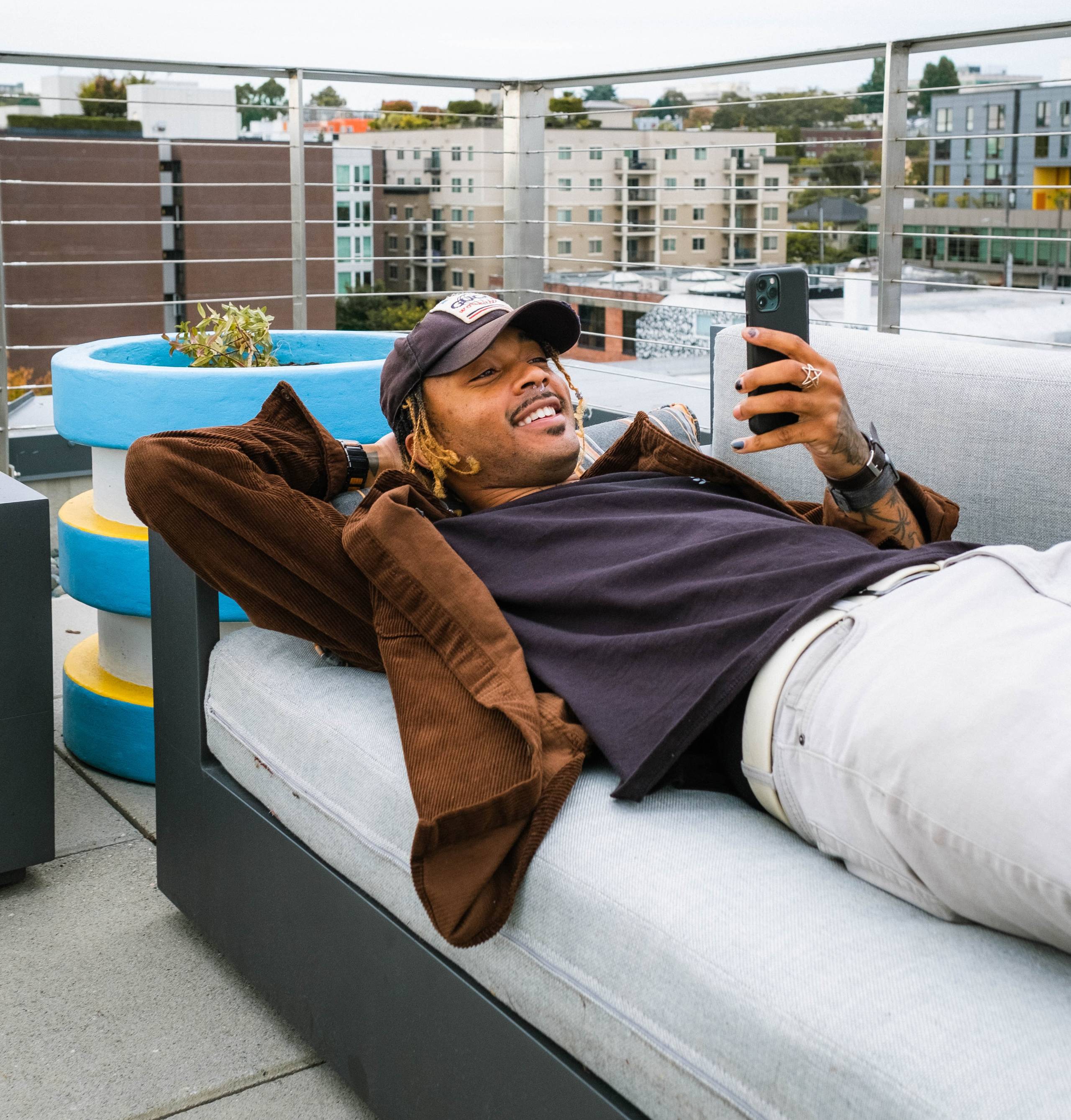 man reclining and using a smartphone