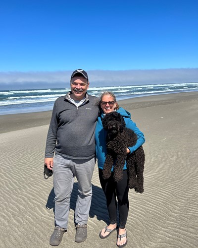 Rebecca Ruhl, husband, and puppy at the beach, 2022