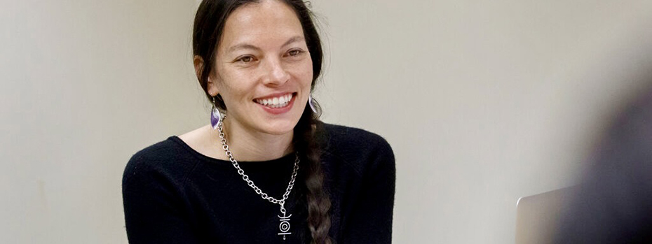 Dr. Amanda Bruegl warmly greets a patient with a smile.