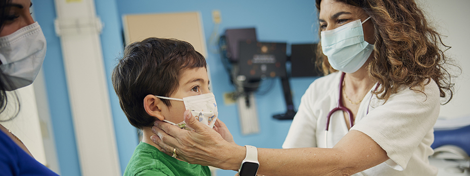 Lisa Crupi examines a patient.