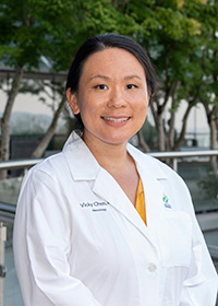 Vicky Chen, M.D., MS fellow, smiling and posed in her white coat